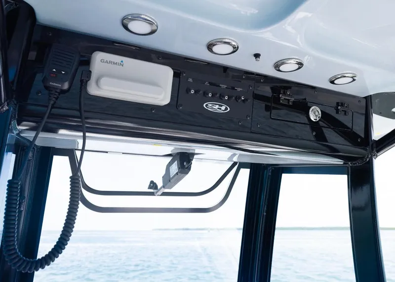 Slide: The Image of 2026 Sea Hunt Gamefish 27 helm with Garmin electronics and sleek black panel design. - 10