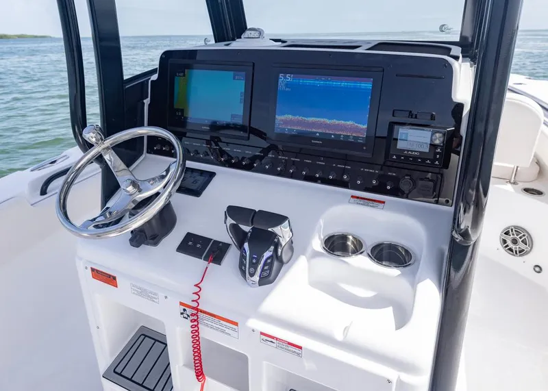 Slide: The Image of 2026 Sea Hunt Gamefish 27 helm with advanced navigation and control systems. - 11
