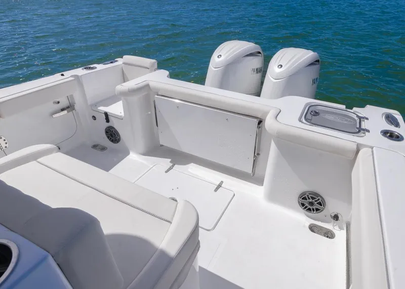 Slide: The Image of 2026 Sea Hunt Gamefish 27 boat interior with seating and twin Yamaha engines. - 14