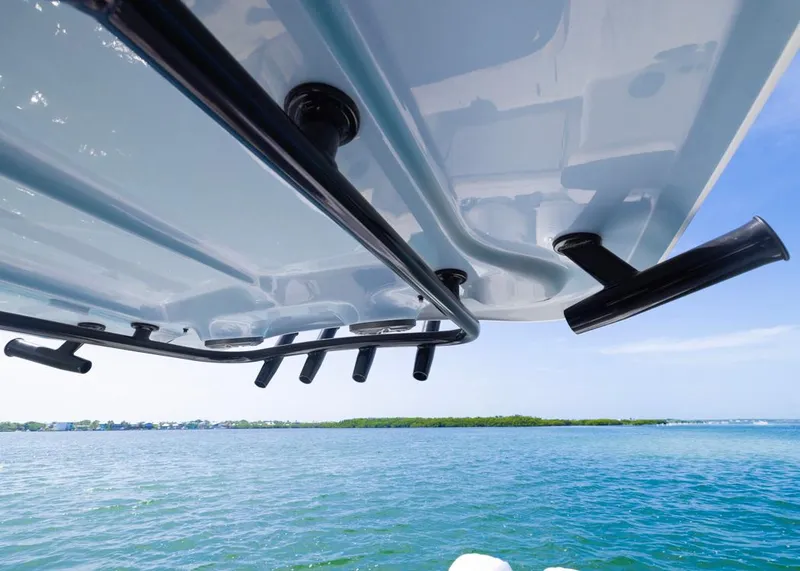 Slide: The Image of 2026 Sea Hunt Gamefish 27 boat with rod holders, ocean view in background. - 17