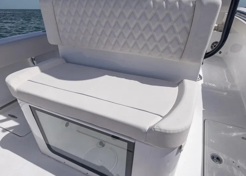 Slide: The Image of 2026 Sea Hunt Gamefish 27 Forward Seating with cushioned bench and storage, on open water. - 19