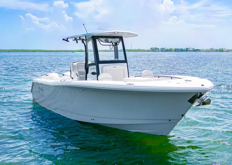 Slide: The Image of 2026 Sea Hunt Gamefish 27 Forward Seating boat on calm blue water. - 2