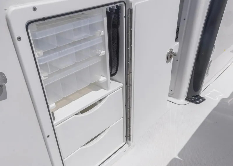 Slide: The Image of Storage compartment on 2026 Sea Hunt Gamefish 27 boat with tackle boxes and drawers. - 20