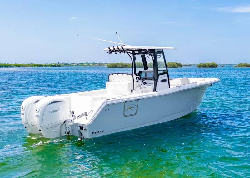 Slide: The Image of 2026 Sea Hunt Gamefish 27 boat on clear blue water, featuring dual Yamaha engines. - 3