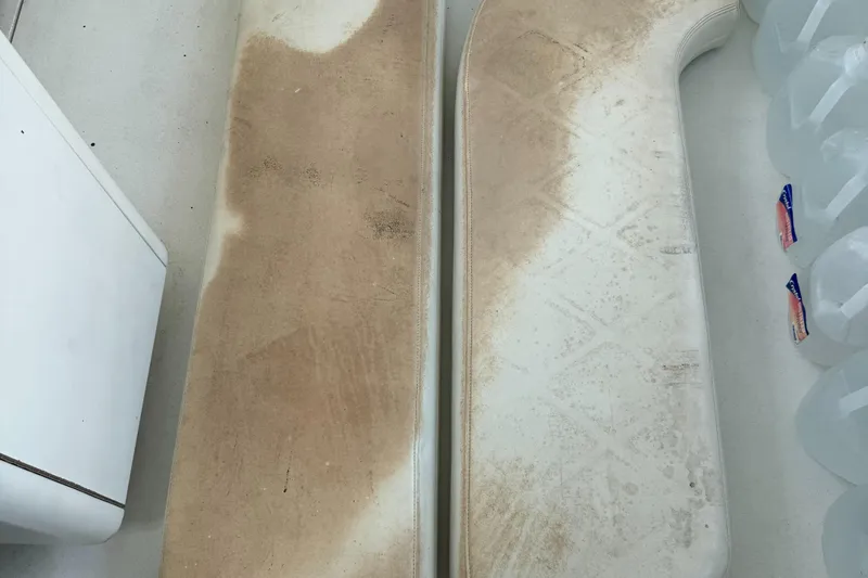 Slide: The Image of Dirty boat cushions on a 1998 Hatteras 39 Sport Express, next to water jugs. - 10