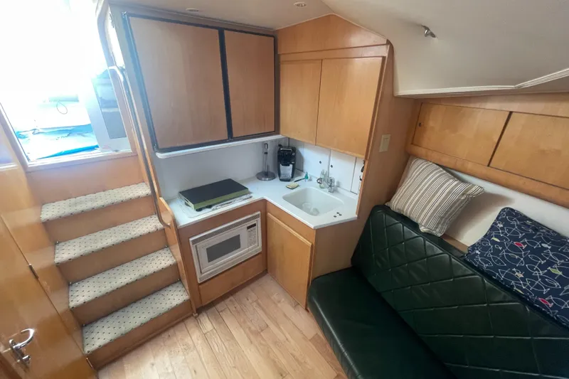 Slide: The Image of Interior of 1998 Hatteras 39 Sport Express with kitchenette and seating area. - 13