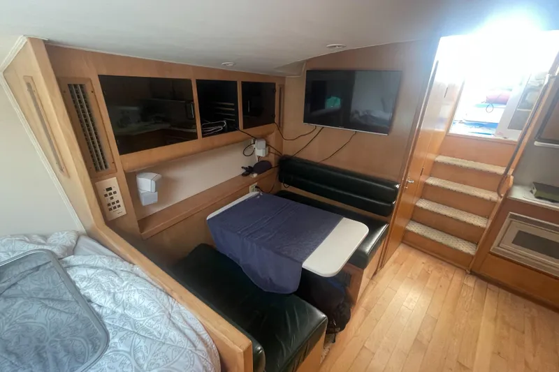 Slide: The Image of Interior of 1998 Hatteras 39 Sport Express, featuring dining area and stairs. - 14