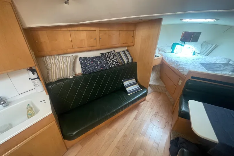 Slide: The Image of 1998 Hatteras 39 Sport Express interior with seating, bed, and kitchenette. - 15