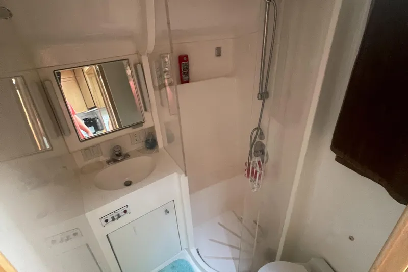 Slide: The Image of Bathroom interior of 1998 Hatteras 39 Sport Express yacht, featuring sink and shower. - 16