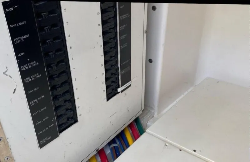 Slide: The Image of Electrical panel of a 1998 Hatteras 39 Sport Express boat with labeled switches. - 17