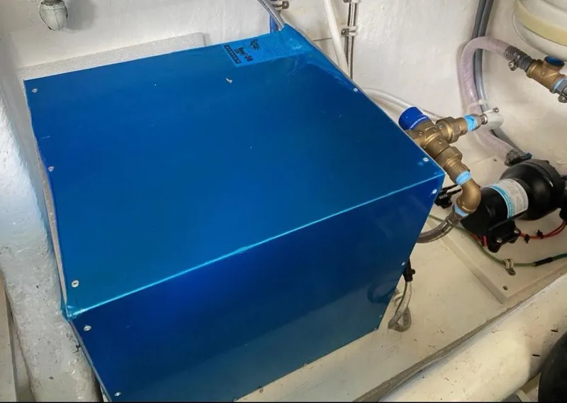 Slide: The Image of Engine room of 1998 Hatteras 39 Sport Express with blue machinery and plumbing components. - 19