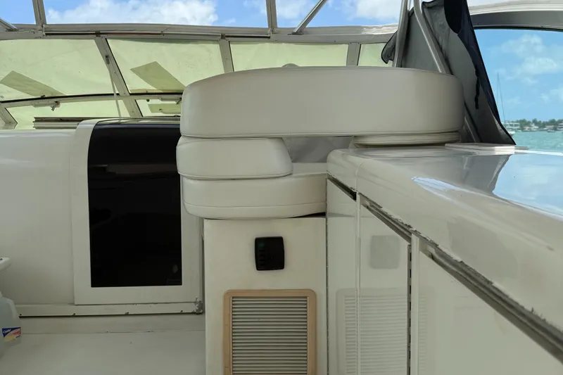 Slide: The Image of Interior of 1998 Hatteras 39 Sport Express yacht with white seating and cabinetry. - 5