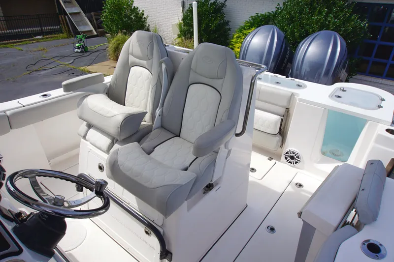 Slide: The Image of 2023 Sea Fox 288 Commander boat interior with dual captain's chairs and steering wheel. - 12
