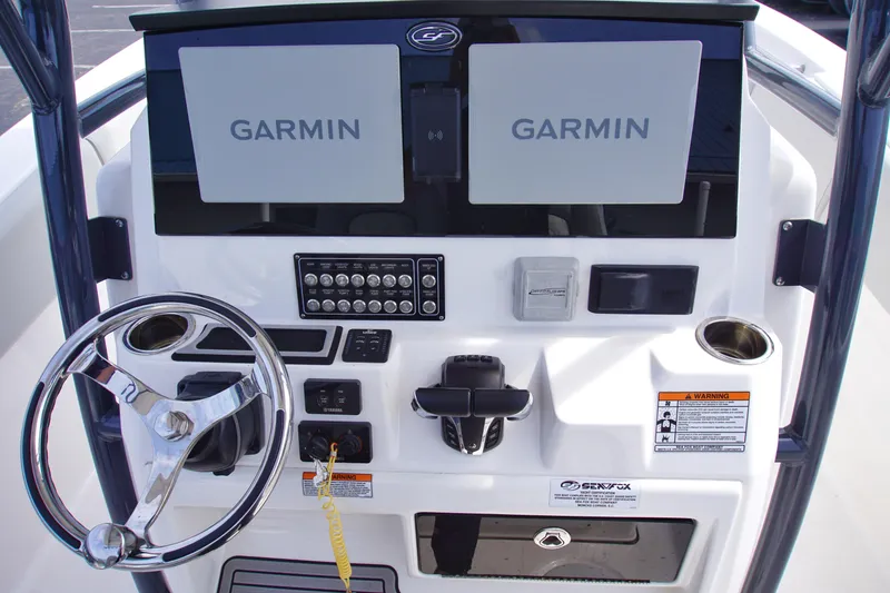 Slide: The Image of 2023 Sea Fox 288 Commander dashboard with dual Garmin displays and steering wheel. - 13