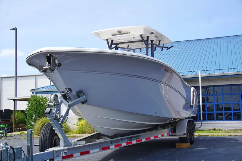 Slide: The Image of 2023 Sea Fox 288 Commander boat on trailer, parked outside a building with blue roof. - 3