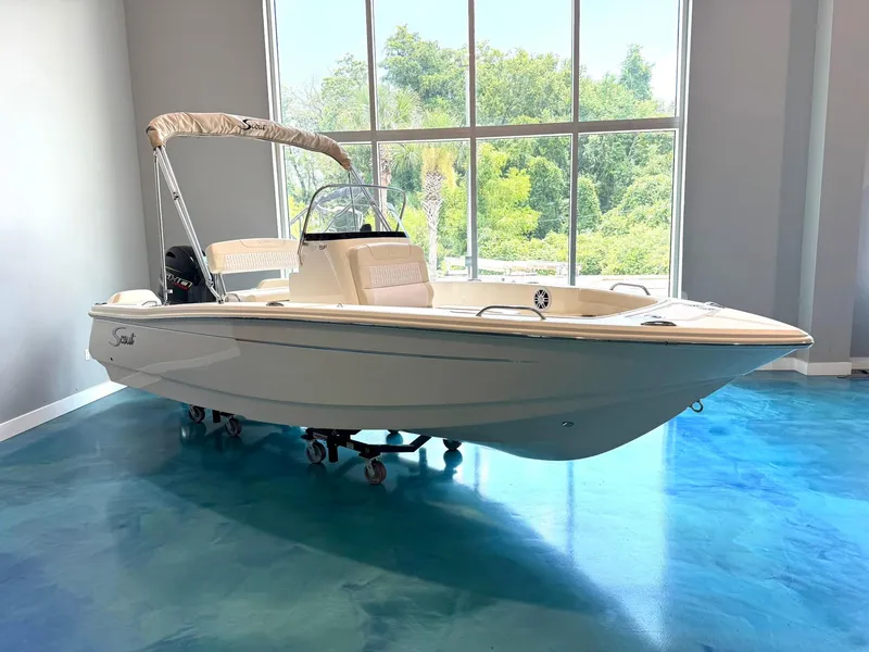 The Image of 2026 Scout 188 SF boat displayed indoors with blue flooring and large windows. - 0