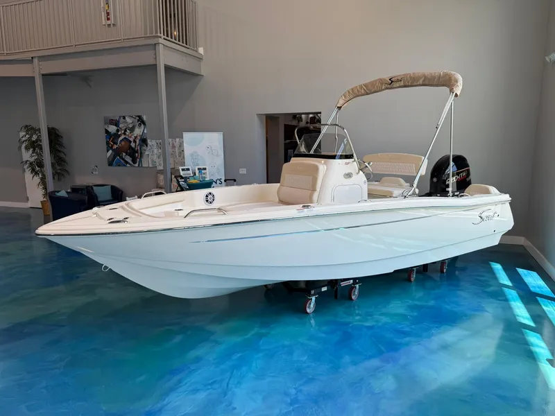 Slide: The Image of 2026 Scout 188 SF boat displayed indoors on a blue floor. - 1