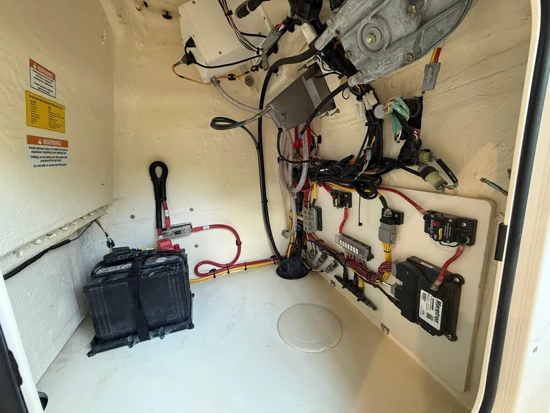 Slide: The Image of 2026 Scout 188 SF boat electrical compartment with battery and wiring setup. - 12