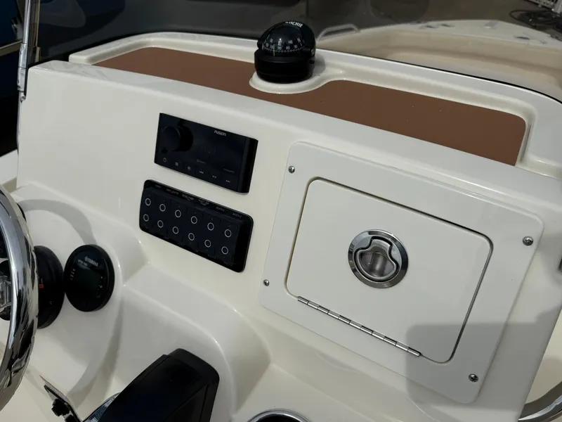 Slide: The Image of 2026 Scout 188 SF boat dashboard with controls and compass. - 14