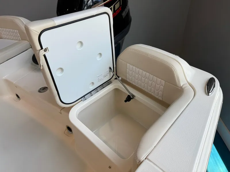 Slide: The Image of 2026 Scout 188 SF boat with open storage compartment and cushioned seating. - 20