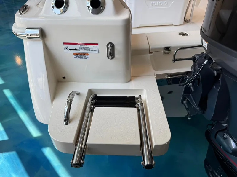 Slide: The Image of 2026 Scout 188 SF boat with stainless steel swim ladder and outboard motor. - 4