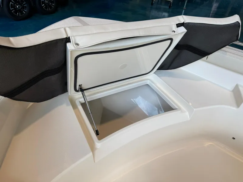 Slide: The Image of 2026 Scout 188 SF boat storage compartment with open lid, showcasing interior space. - 6