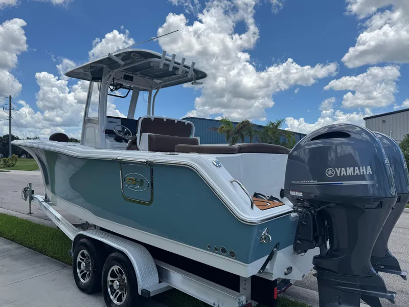 Slide: The Image of 2019 Sea Hunt Ultra 275 SE boat with Yamaha engine on trailer under blue sky. - 15