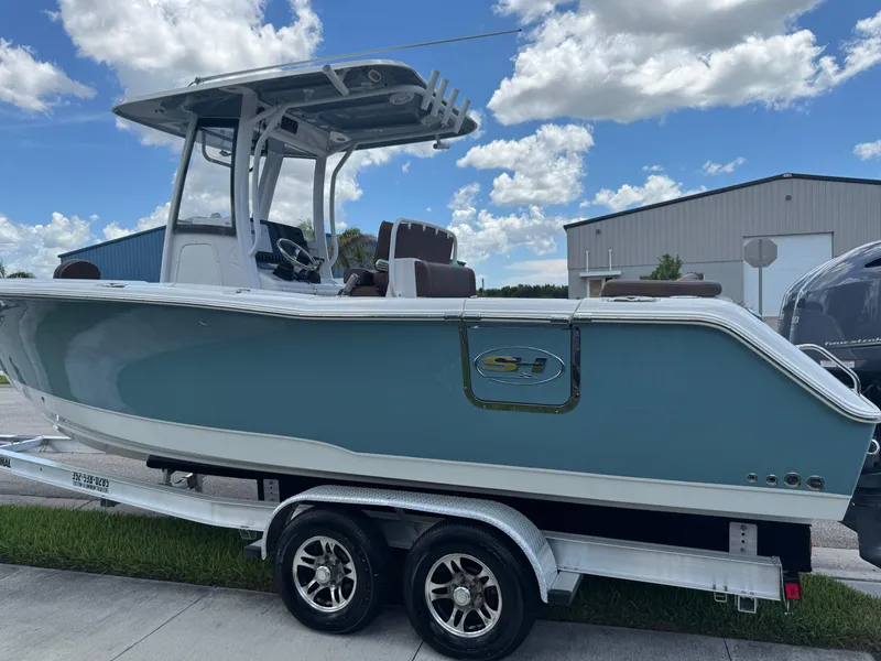 Slide: The Image of 2019 Sea Hunt Ultra 275 SE boat on trailer under blue sky. - 16