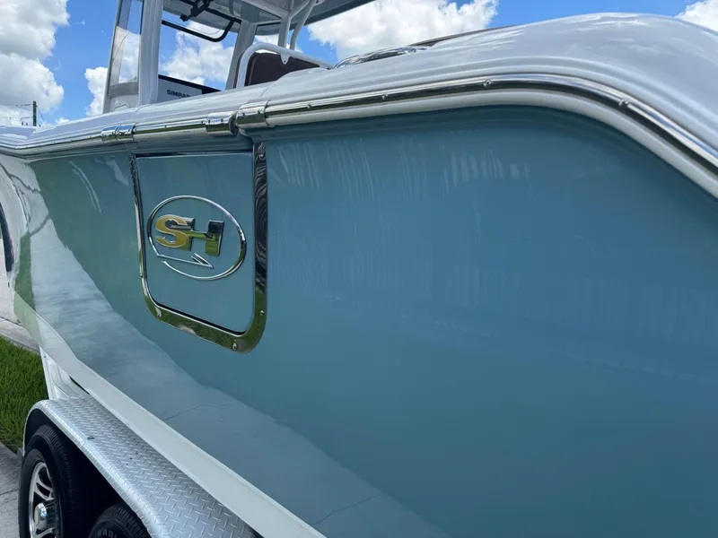 Slide: The Image of 2019 Sea Hunt Ultra 275 SE boat side view with logo, under blue sky. - 17