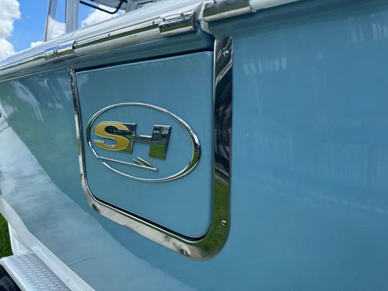 Slide: The Image of 2019 Sea Hunt Ultra 275 SE boat with SH logo on blue hull. - 18
