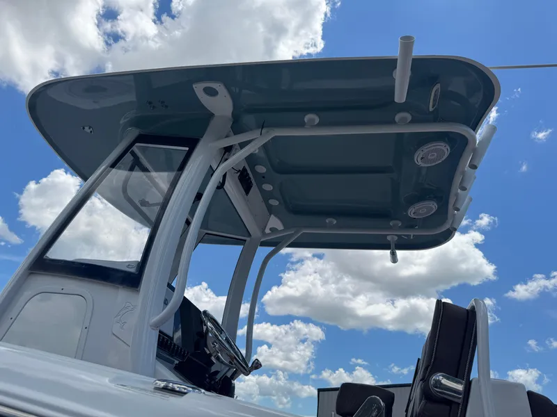 Slide: The Image of 2019 Sea Hunt Ultra 275 SE boat console and T-top against a blue sky. - 19
