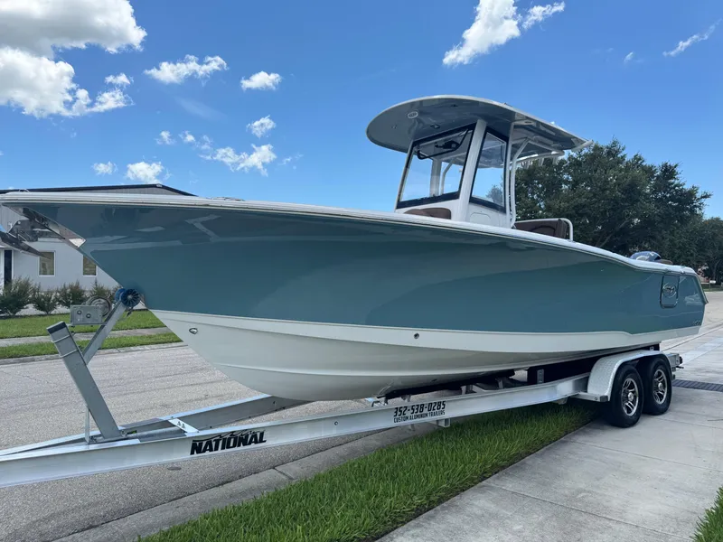 Slide: The Image of 2019 Sea Hunt Ultra 275 SE boat on trailer under clear blue sky. - 20