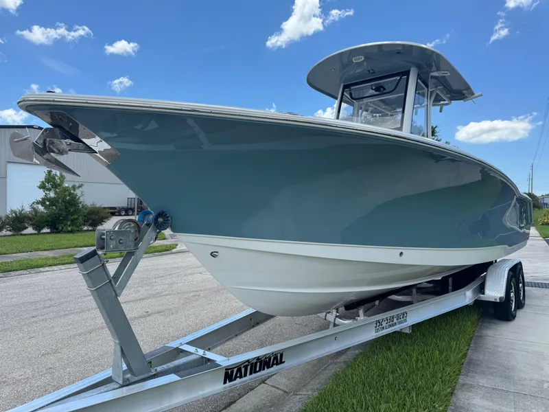 Slide: The Image of 2019 Sea Hunt Ultra 275 SE boat on trailer under clear blue sky. - 21