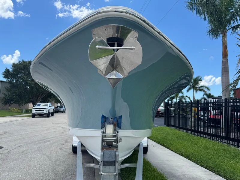 Slide: The Image of 2019 Sea Hunt Ultra 275 SE boat on trailer, parked on street with palm trees. - 22
