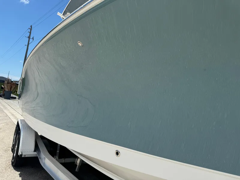 Slide: The Image of 2019 Sea Hunt Ultra 275 SE boat on trailer under clear blue sky. - 24