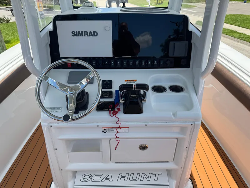 Slide: The Image of 2019 Sea Hunt Ultra 275 SE boat console with steering wheel and Simrad display. - 26