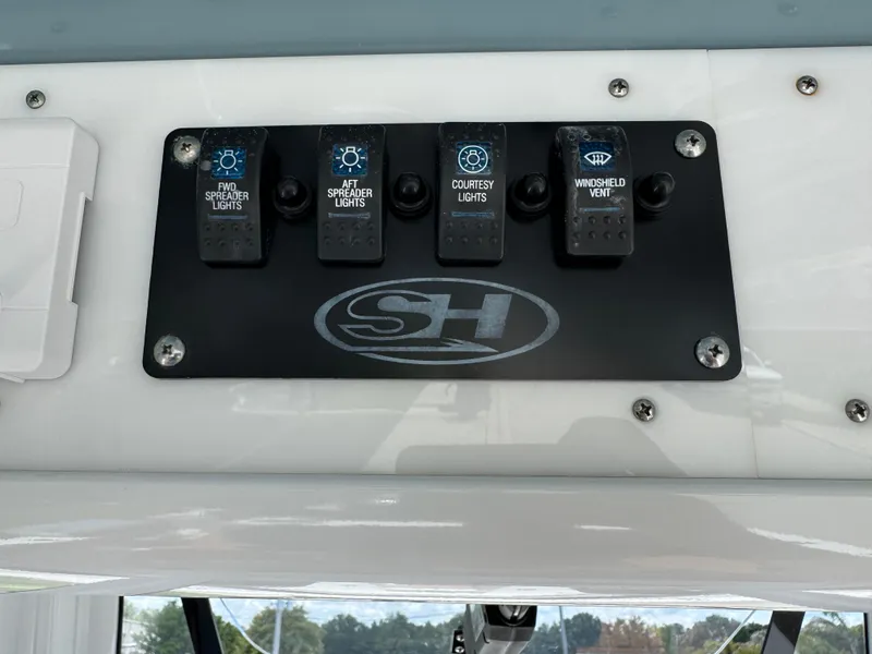 Slide: The Image of Control panel of 2019 Sea Hunt Ultra 275 SE boat with labeled switches. - 33