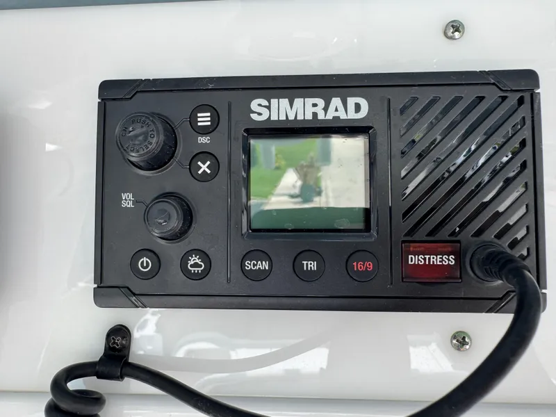 Slide: The Image of Simrad marine radio on 2019 Sea Hunt Ultra 275 SE boat dashboard. - 35
