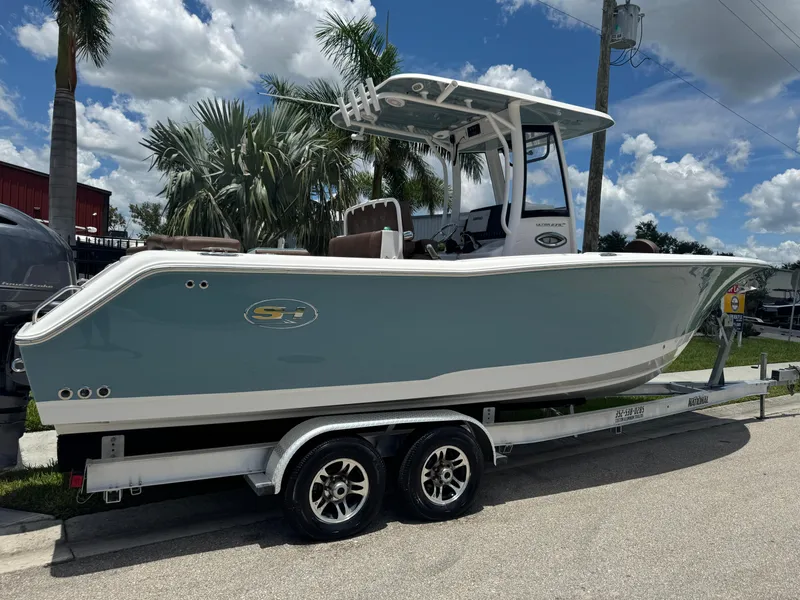 Slide: The Image of 2019 Sea Hunt Ultra 275 SE boat on trailer, parked outdoors under a sunny sky. - 4
