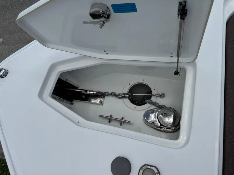 Slide: The Image of Anchor compartment of 2019 Sea Hunt Ultra 275 SE boat, featuring chain and winch. - 45