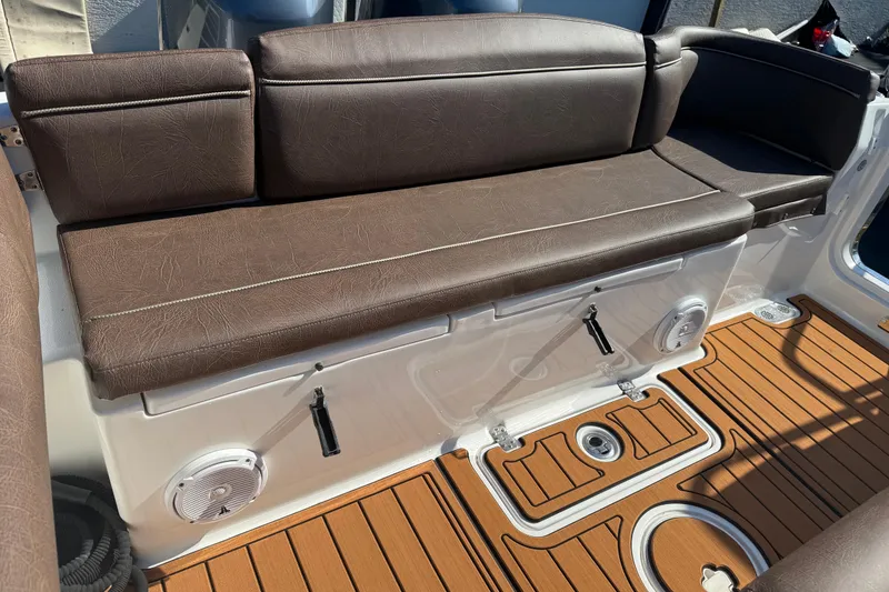 Slide: The Image of 2019 Sea Hunt Ultra 275 SE boat interior with brown seating and teak-style flooring. - 69
