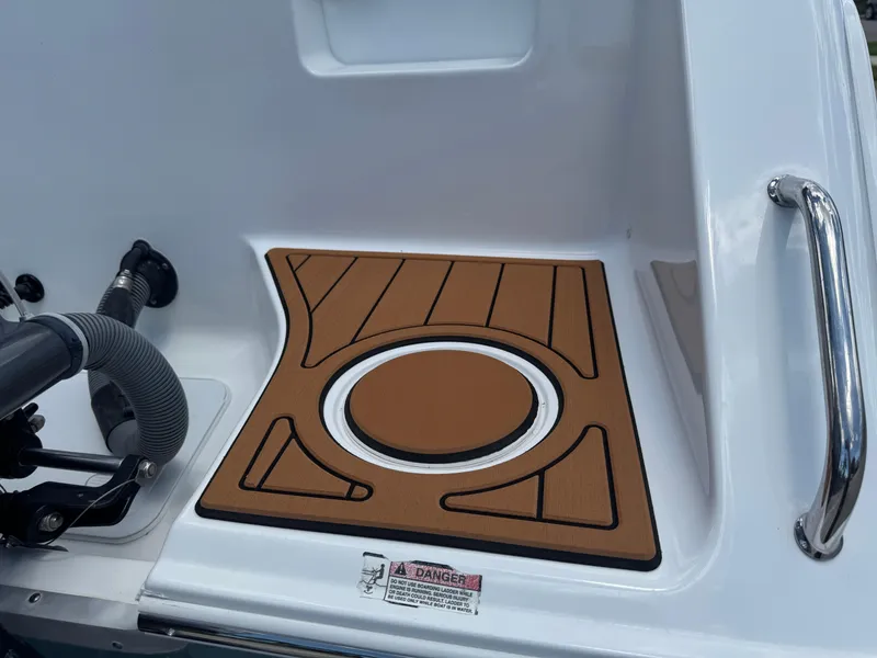 Slide: The Image of 2019 Sea Hunt Ultra 275 SE boat deck with brown non-slip mat and safety handle. - 7