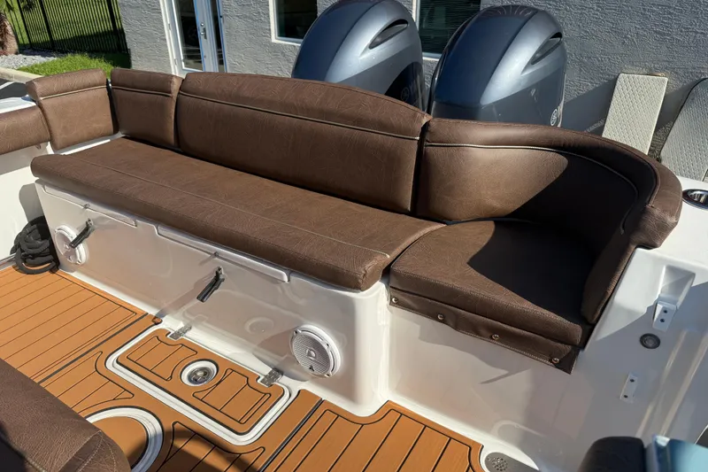 Slide: The Image of 2019 Sea Hunt Ultra 275 SE boat with brown leather seating and teak flooring. - 70