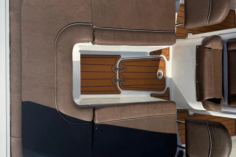 Slide: The Image of 2019 Sea Hunt Ultra 275 SE boat interior with brown seating and teak flooring. - 71
