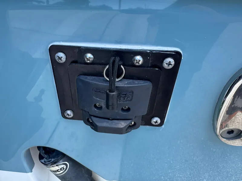 Slide: The Image of 2019 Sea Hunt Ultra 275 SE boat detail with mounted accessory on blue hull. - 9