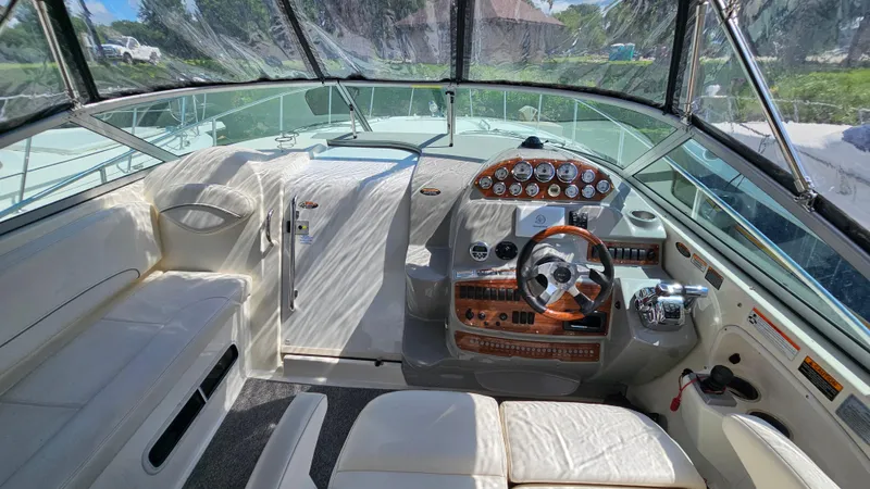 Slide: The Image of 2009 Bayliner 340 SB boat cockpit with steering wheel and control panel. - 12