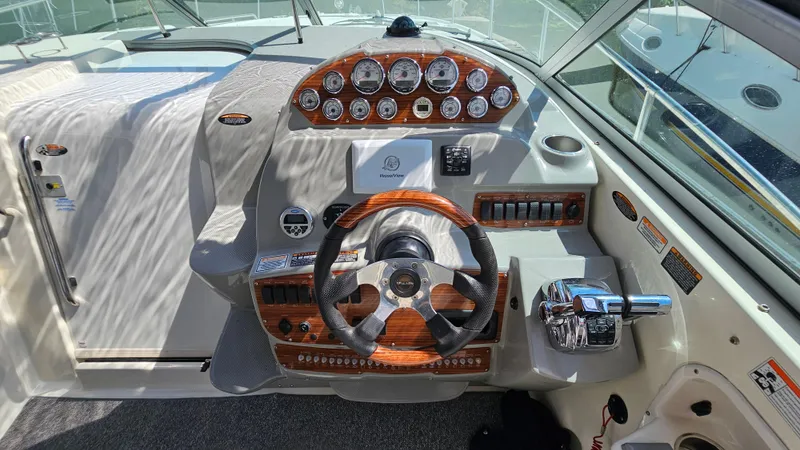 Slide: The Image of 2009 Bayliner 340 SB boat dashboard with steering wheel and control panel. - 13