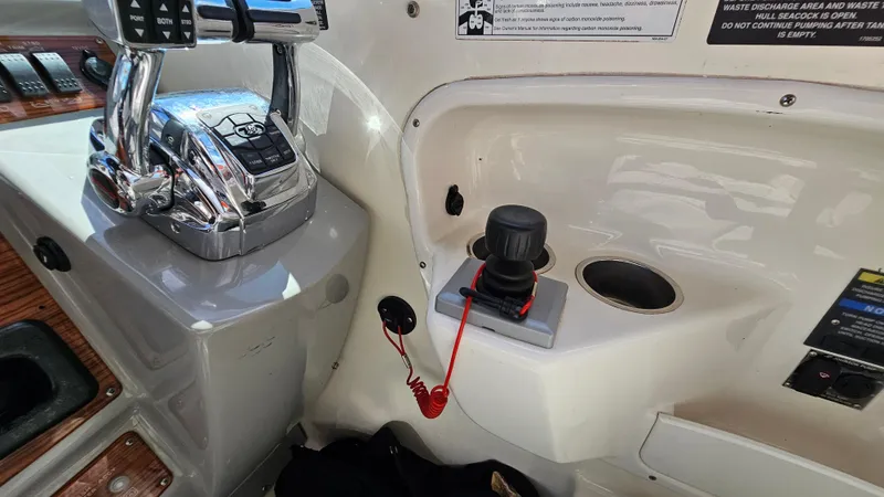 Slide: The Image of Control panel of a 2009 Bayliner 340 SB boat with throttle and joystick. - 14