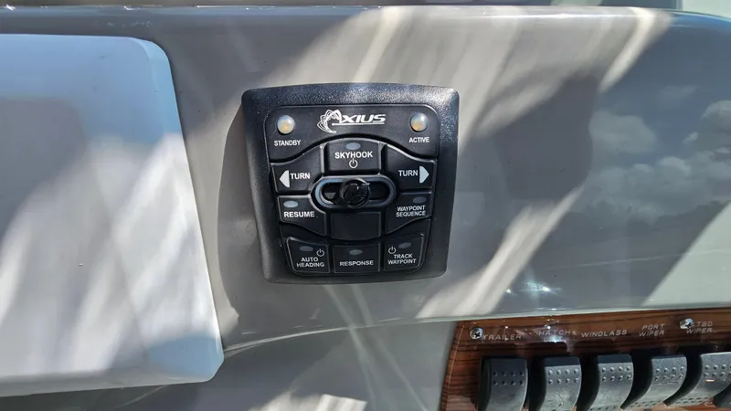 Slide: The Image of Control panel on a 2009 Bayliner 340 SB boat dashboard with Axius system. - 15
