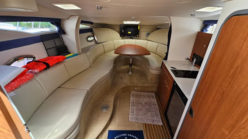 Slide: The Image of Interior of 2009 Bayliner 340 SB yacht with seating, table, and kitchenette. - 16